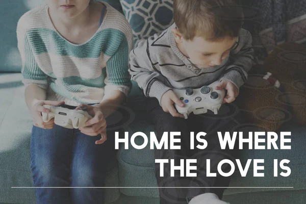 Brother and sister playing with joysticks — Stock Photo, Image