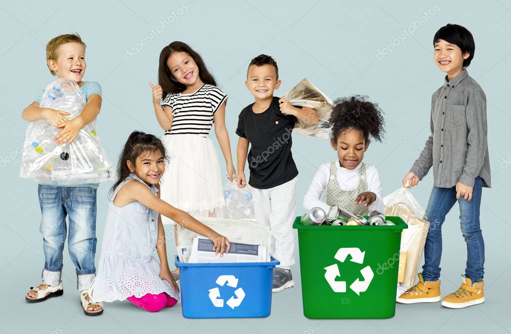 Group of adorable kids with waste for recycling