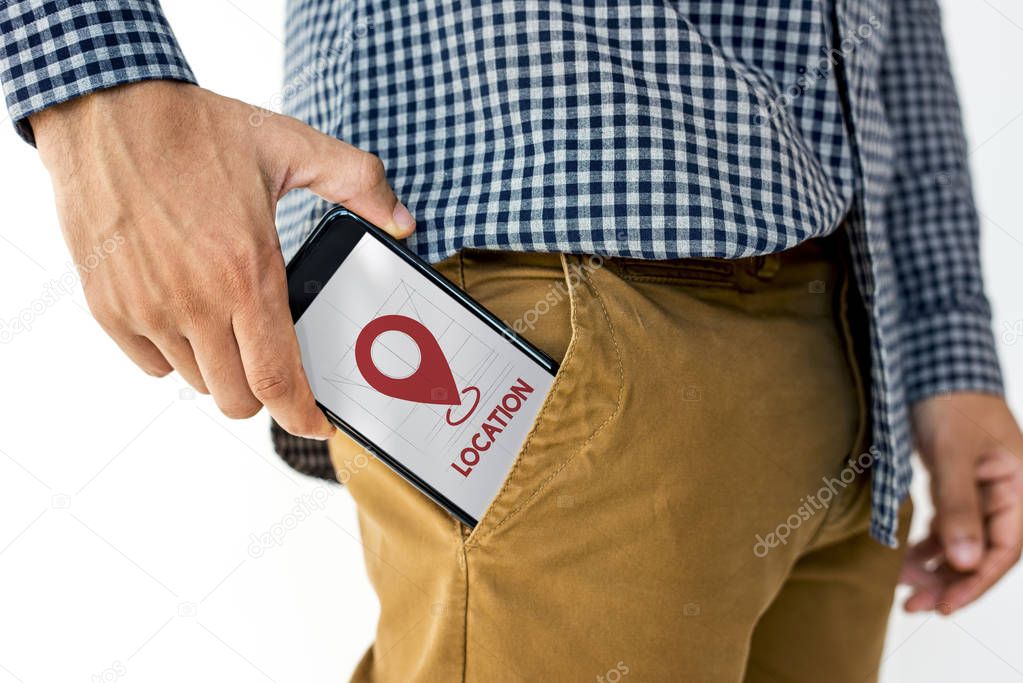 hand putting smartphone into pocket