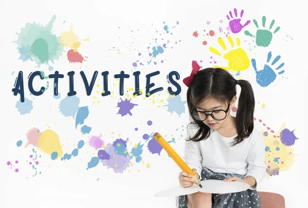 Cute little girl writing with big pencil — Stock Photo, Image