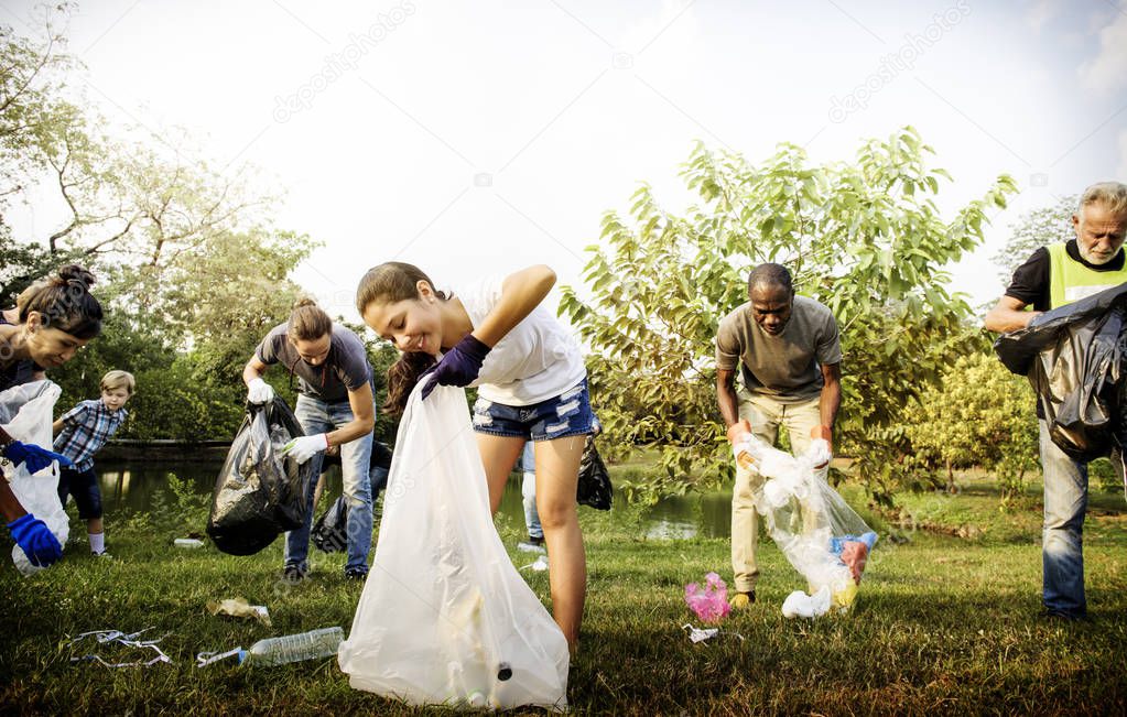 People Picking Up Trash in The Park