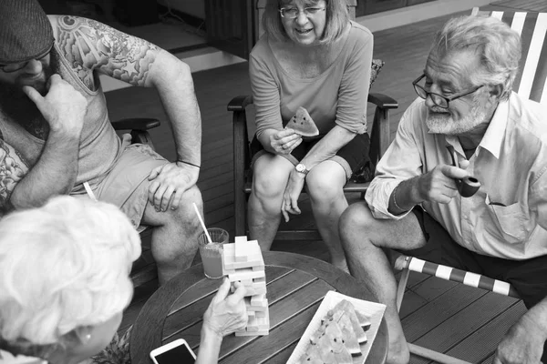 Senior people playing jenga game — Stock Photo, Image