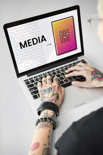 Tatuerade person att skriva på laptop. — Stockfoto