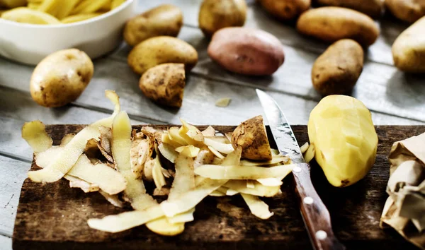 raw potato on chopping board