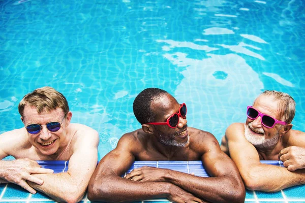 senior men resting in pool