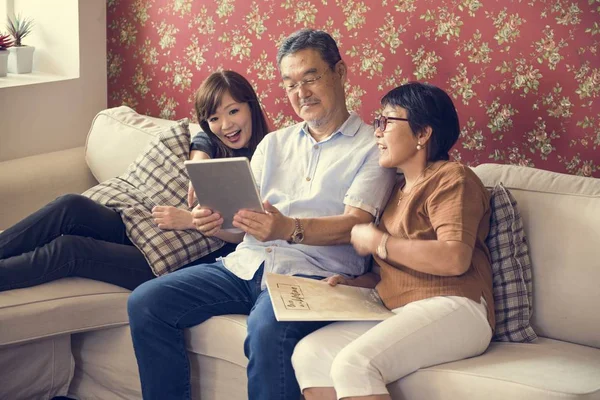 family using digital tablet at home