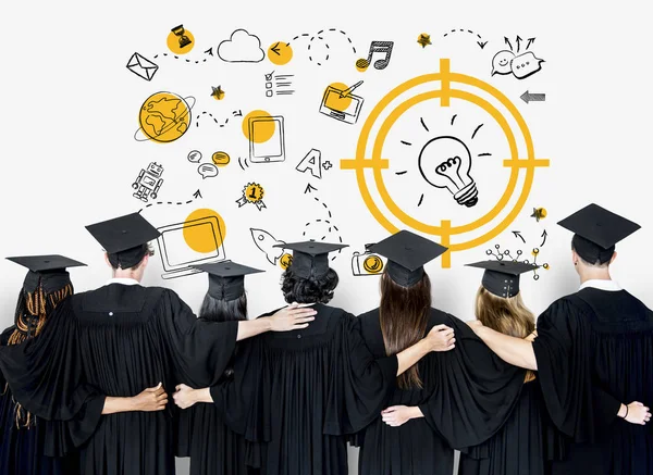 Students wearing graduation caps and gowns — Stock Photo, Image
