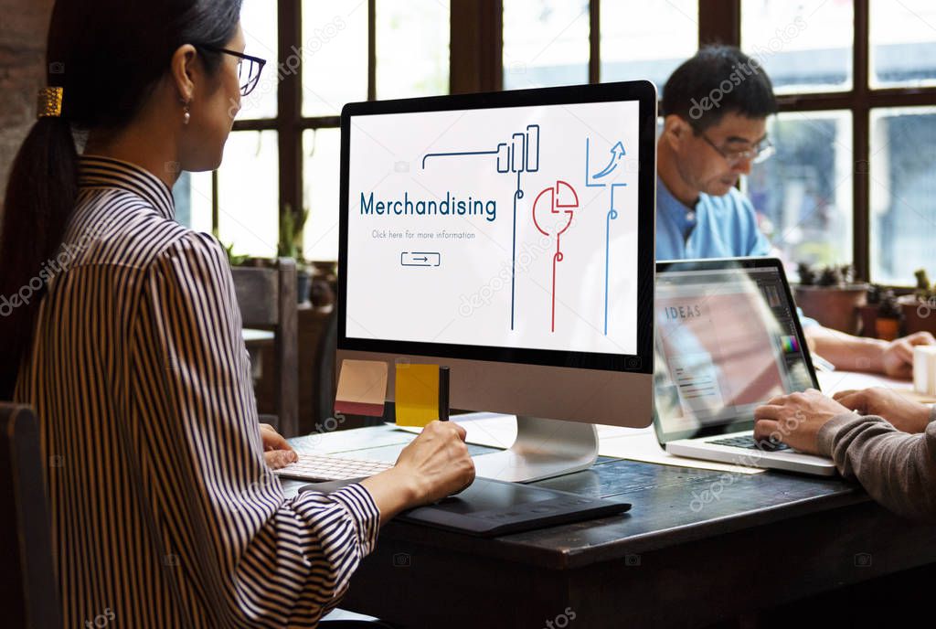 Asian business people working in modern office and using computer and laptop, monitor screen with title: Merchandising