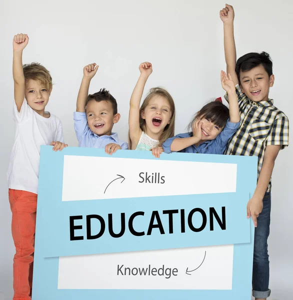 Little children holding placard — Stock Photo, Image