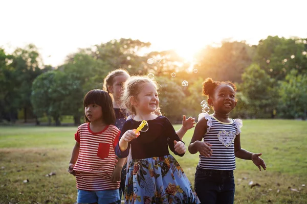 Children blowing bubbles — Stock Photo, Image