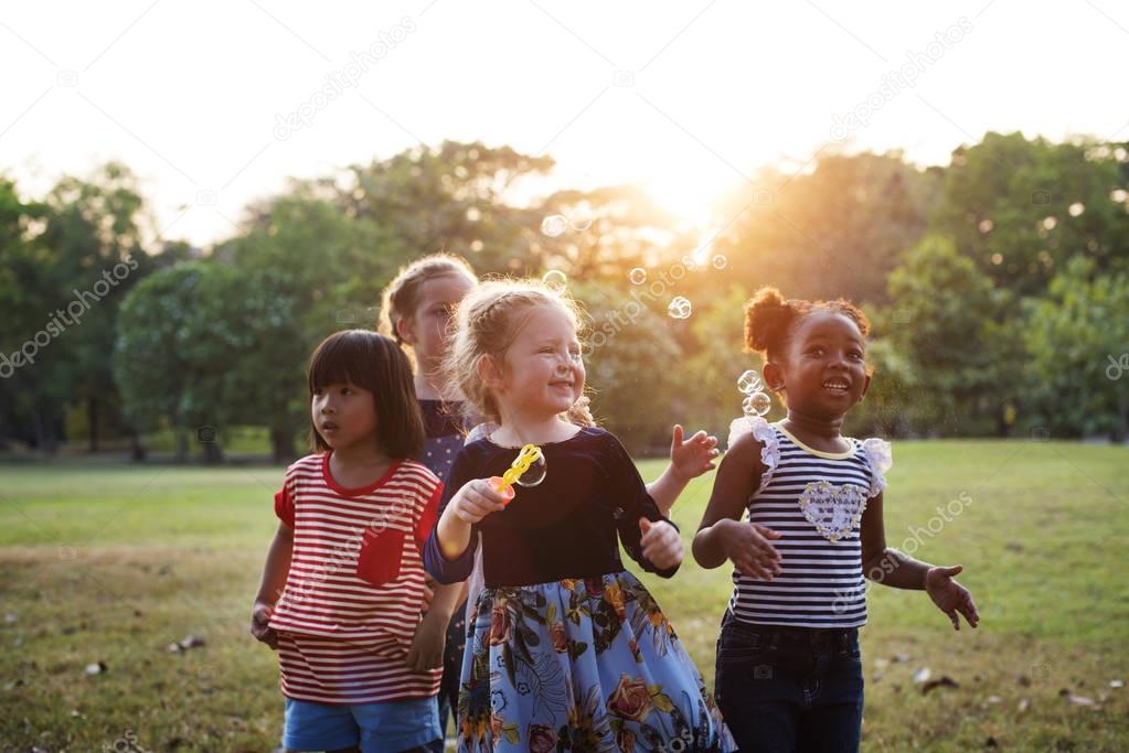 children blowing bubbles