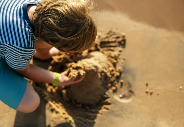 Хлопчик грає з піском — стокове фото