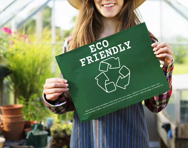 Woman holding banner in greenhouse — Stock Photo, Image