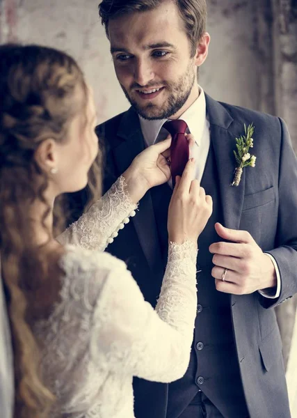 Noiva ajudando o noivo se vestindo — Fotografia de Stock