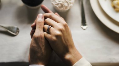 Gelin ve damat el ele tutuşuyorlar.