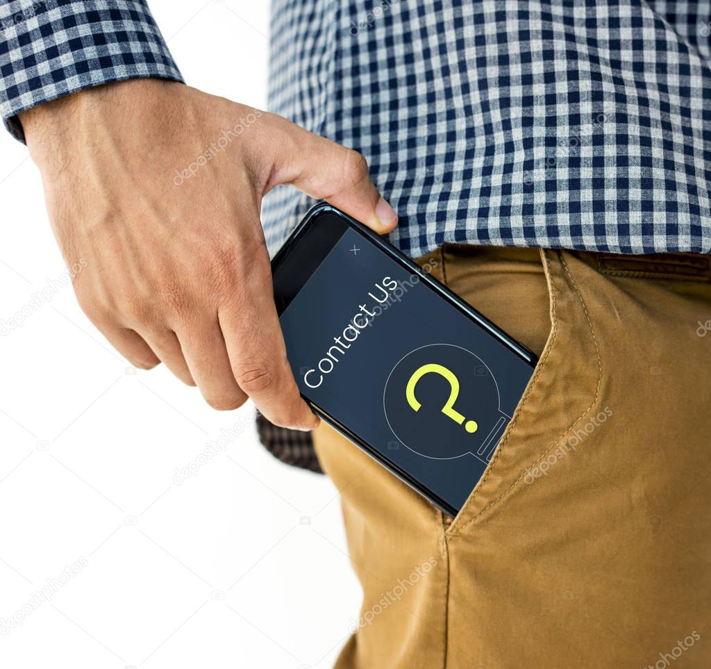 male hand putting smartphone in pocket
