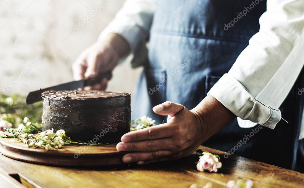 baker man decorating cake