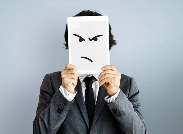 Businessman covering face with digital tablet — Stock Photo, Image