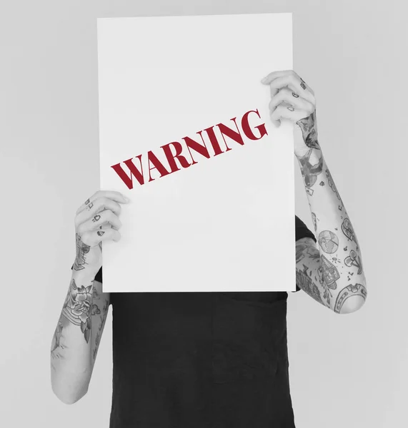 Tattooed woman holding placard — Stock Photo, Image