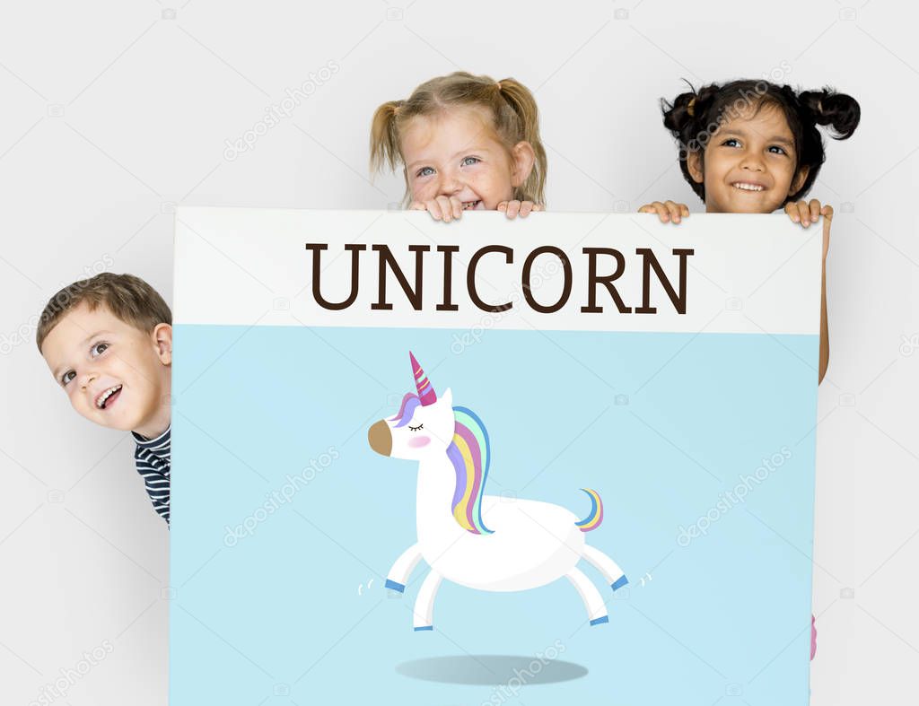 Little funny children hiding behind placard, title on banner: Unicorn
