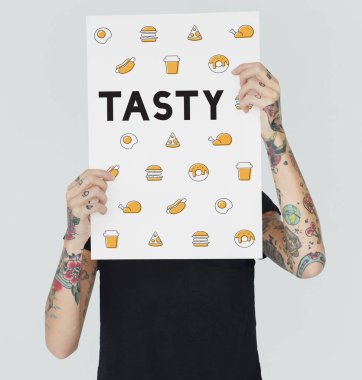 afişini tutan dövmeli kadın