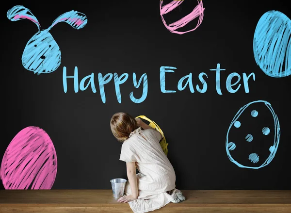 Girl sitting and drawing on chalkboard — Stock Photo, Image