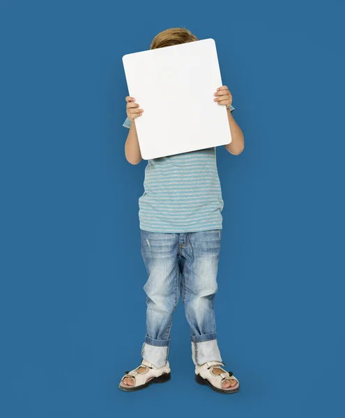 boy covering face with blank placard