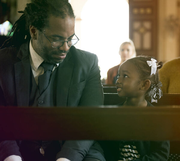 Father and Daughter Sitting in the Church
