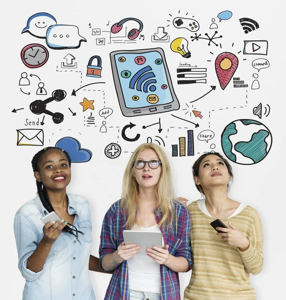 Young women using digital devices — Stock Photo, Image