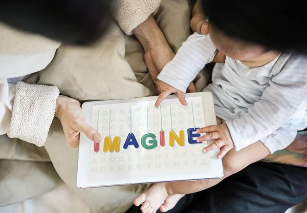 Parents giving tablet to little baby — Stock Photo, Image