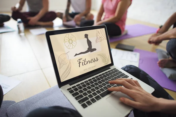 Person benutzt Laptop beim Yoga-Kurs — Stockfoto