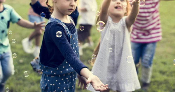 Children blowing bubbles — Stock Photo, Image