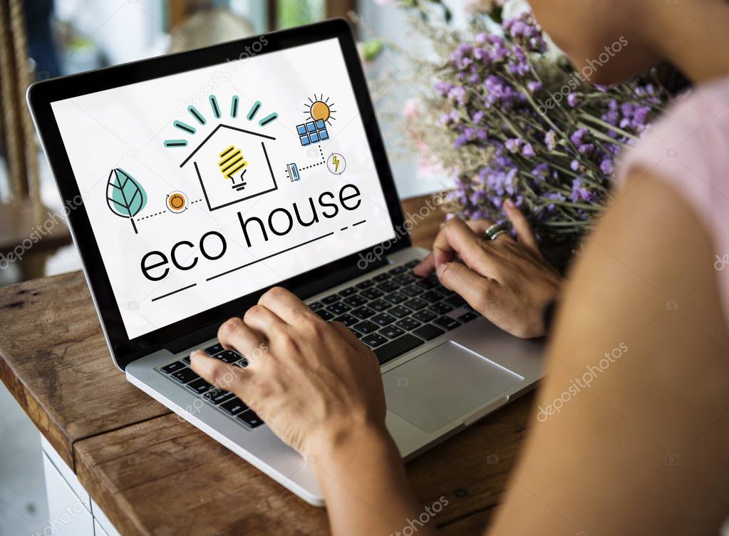 Person typing on laptop with graphic with Eco House on screen