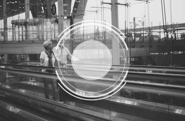 Senior couple standing on escalator in airport — Stock Photo, Image