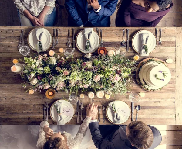 Bride and groom celebrating with guests — Stock Photo, Image