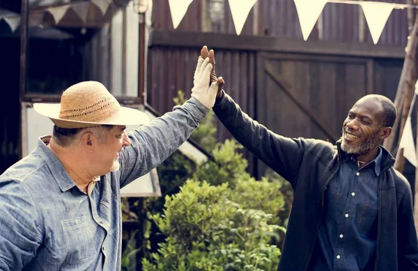 Homens dando alta cinco no quintal — Fotografia de Stock