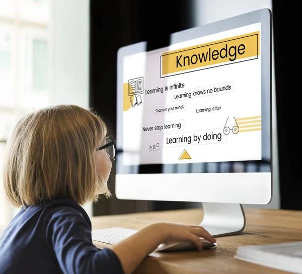 Little girl looking at monitor screen — Stock Photo, Image