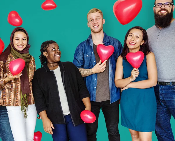 People with balloons in shape of heart — Stock Photo, Image