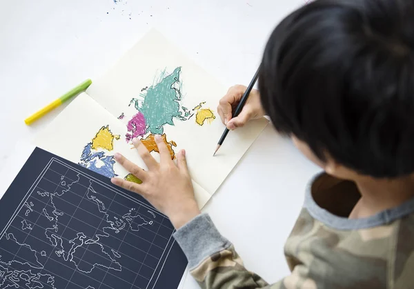 Kid Writing on Paper — Stock Photo © lenmdp #7598945