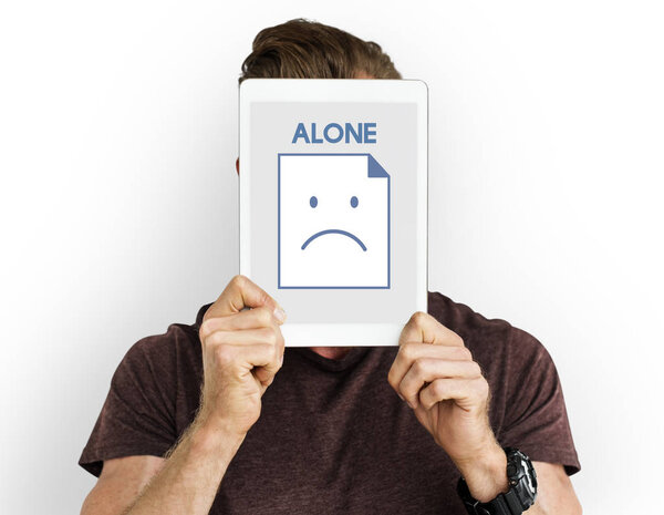 man holding digital tablet covering face