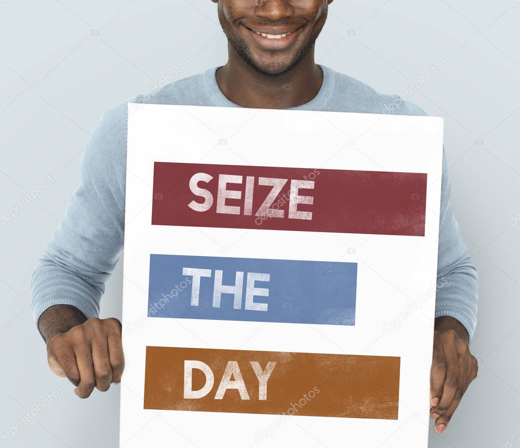 African man holding graphic banner 