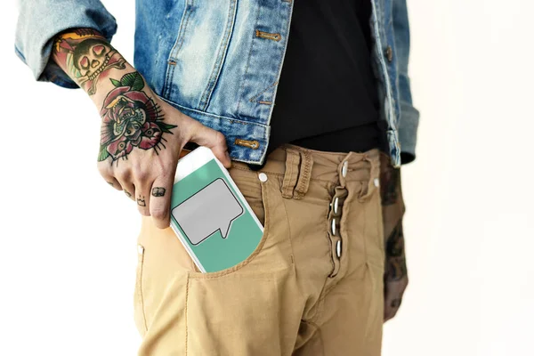 Hand putting smartphone in pocket — Stock Photo, Image