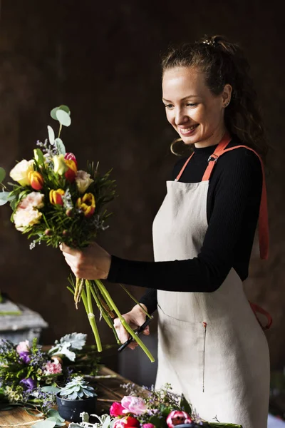 florist woman creating bouquet