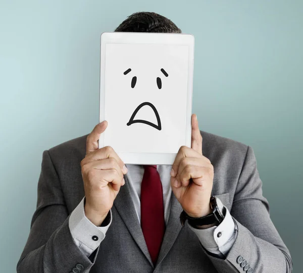 Businessman covering face with digital tablet — Stock Photo, Image