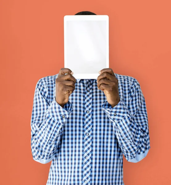 person covering face with digital tablet