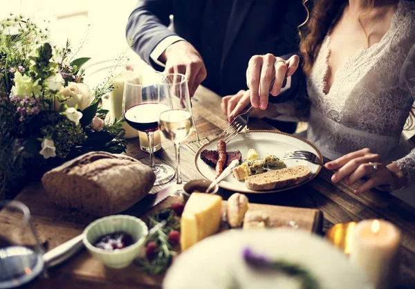 Bruid en bruidegom maaltijd met vrienden — Stockfoto