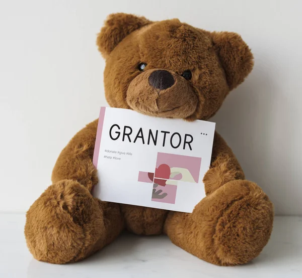 Teddy bear holding placard — Stock Photo, Image