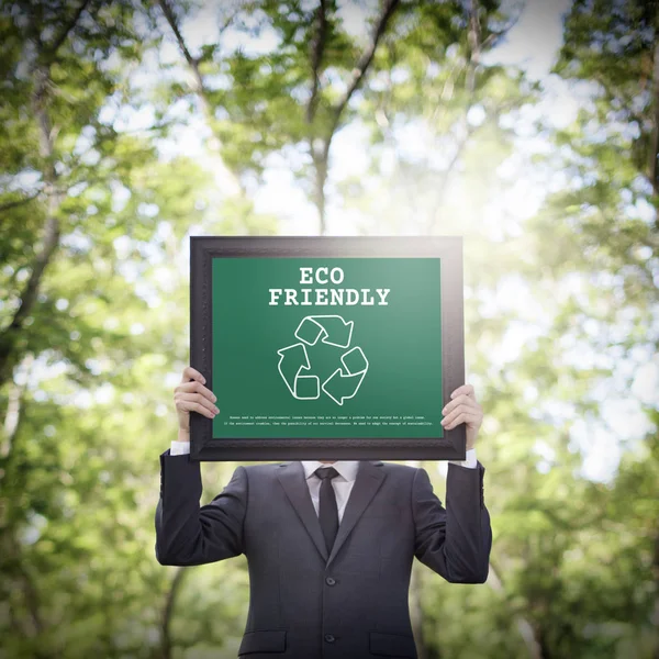 Businessman holding placard — Stock Photo, Image