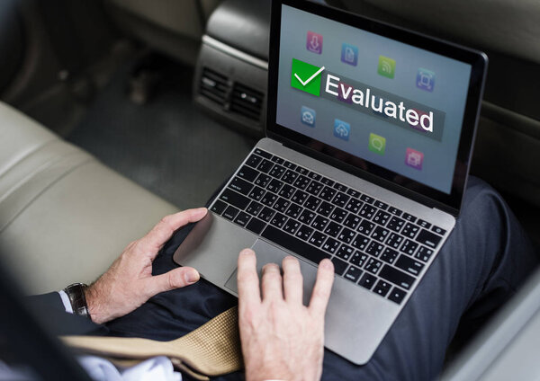Businessperson using laptop in car