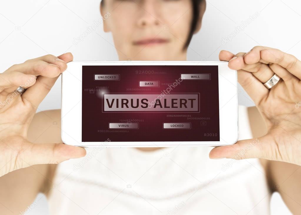 Woman showing mobile screen with text: Virus Alert